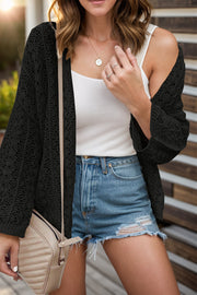 Black open-knit crochet sleeve cardigan with a relaxed fit, styled with a white tank and denim shorts.
