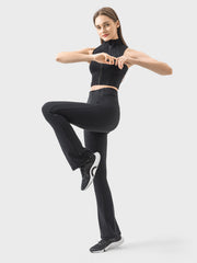 Black sculpted flare active trousers with zip detail and a model in a matching zip top.