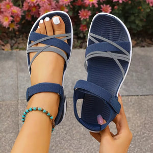 Blue open-toe sandals with criss-cross straps and adjustable ankle strap.
