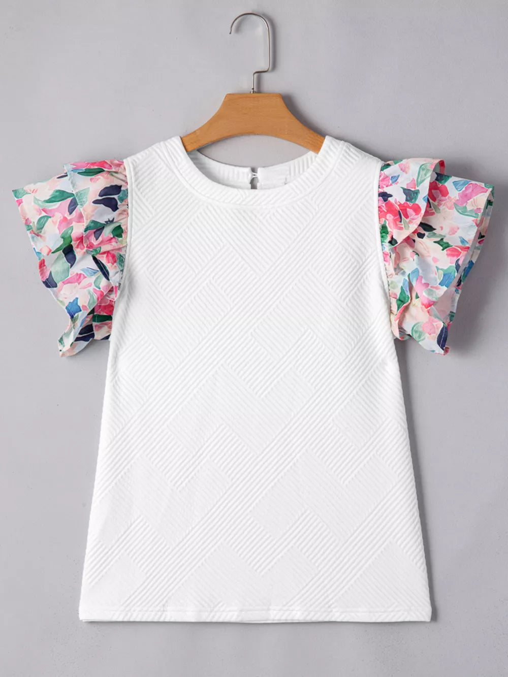 White geometric knit top with floral ruffled sleeves