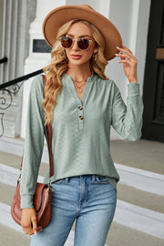 Sage textured henley blouse with button detail and long sleeves.