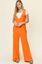 Orange wide-leg jumpsuit with deep V-neck, sleeveless, and side pockets.