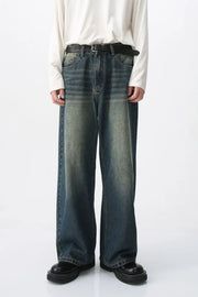 Faded wash wide-leg denim jeans in medium blue with a relaxed fit.