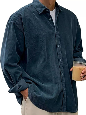 Men's navy blue corduroy button-up shirt with classic collar and long sleeves.