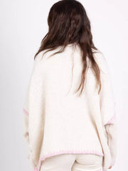 Cream oversized cardigan with pink contrast trim detail.