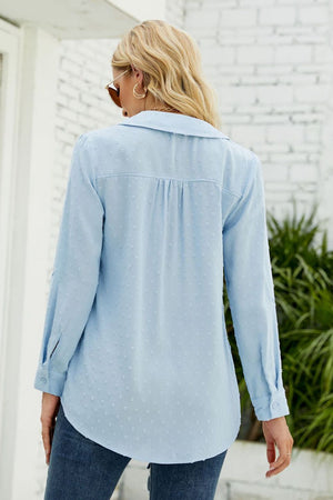 Light blue textured collared blouse with button cuffs and a curved hem.