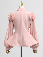 Pink skirt suit with ruffled shoulder detail and pleated balloon sleeves.