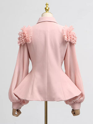 Pink skirt suit with ruffled shoulder detail and pleated balloon sleeves.