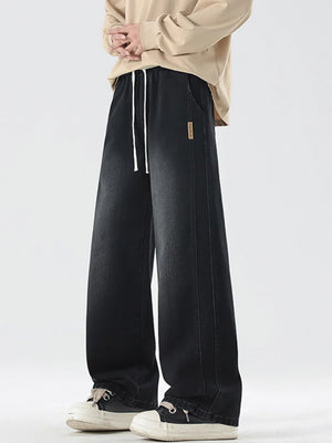 Oversized black washed denim jeans with drawstring waist and wide leg