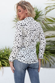 Dalmatian print button-up shirt in white with black spots, long sleeves, and knot front detail.