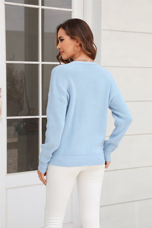 Light blue ribbed knit V-neck sweater with long sleeves and a relaxed fit.