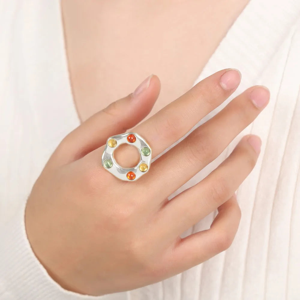 Silver statement ring with colorful gemstone halo detail