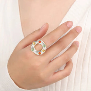 Silver statement ring with colorful gemstone halo detail