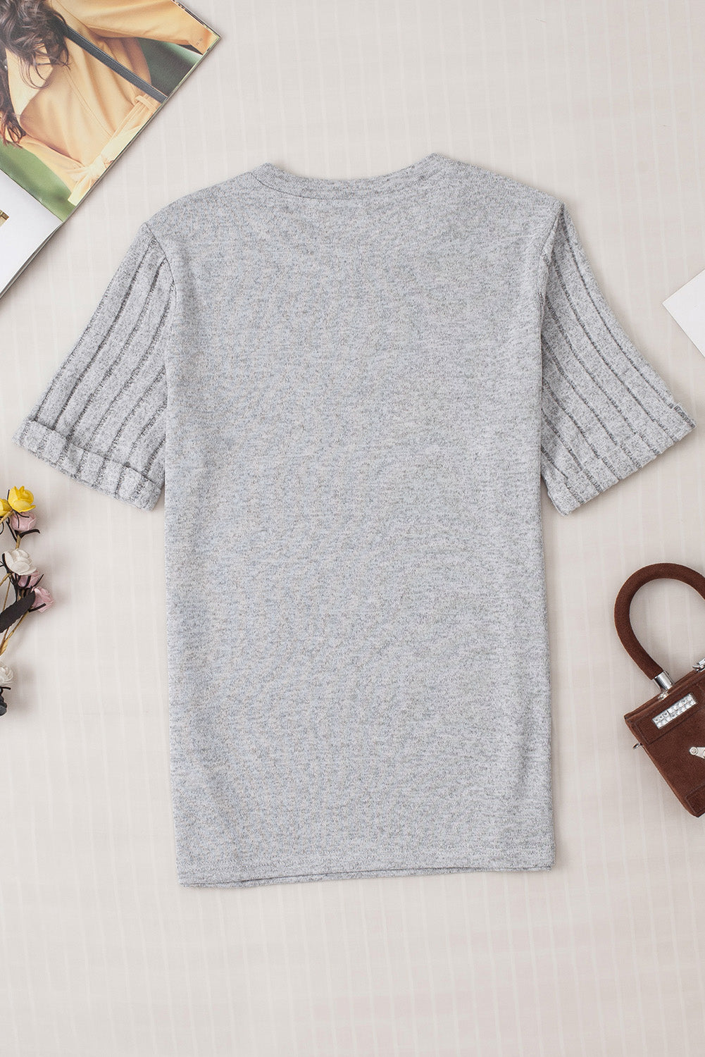 Gray t-shirt with ribbed short sleeves and a rolled cuff detail.