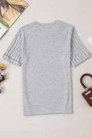 Gray t-shirt with ribbed short sleeves and a rolled cuff detail.