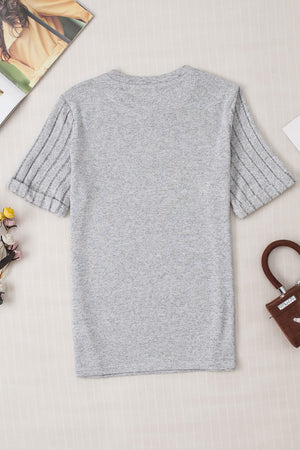 Gray t-shirt with ribbed short sleeves and a rolled cuff detail.