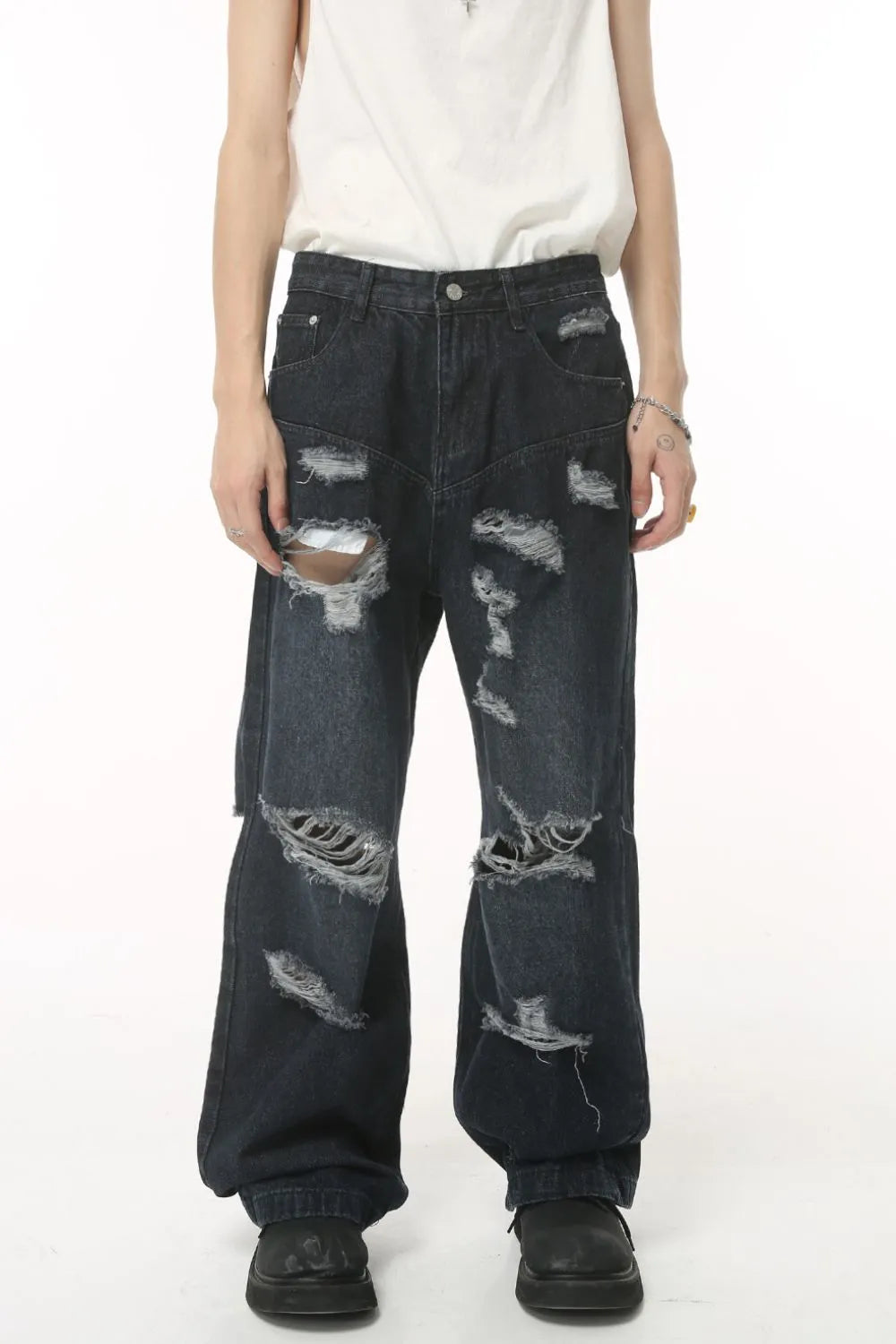 Distressed baggy dark wash denim jeans with statement rips and a relaxed fit.