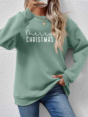 Sage green crewneck sweatshirt with white Merry Christmas graphic, casual relaxed fit.
