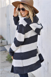 Chunky knit hooded cardigan in cream with dark grey stripes, open front, and long sleeves.