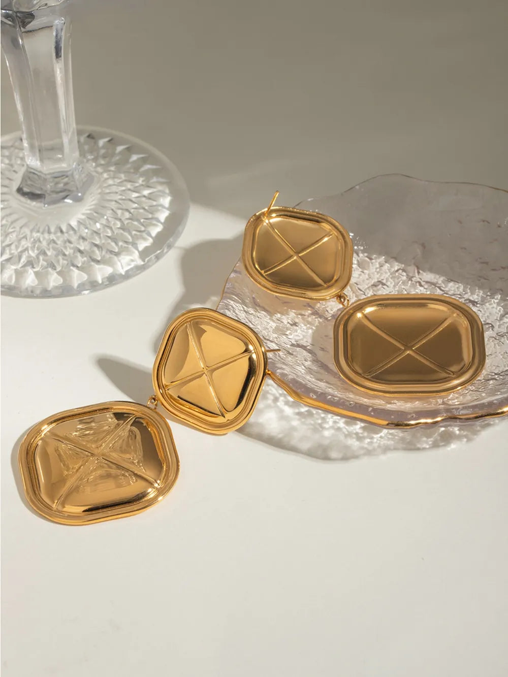 Sculpted geo drop earrings in gold-plated metal with a unique geometric design.