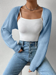 Light blue acrylic knit bolero shrug with long sleeves and ribbed texture.