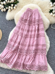 Pink tiered maxi skirt with lace trim and drawstring waist.