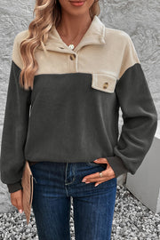 Colorblock fleece button-up pullover in dark gray and beige with a chest pocket.