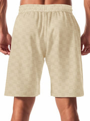 Men's beige checkered drawstring chino shorts with elastic waistband.