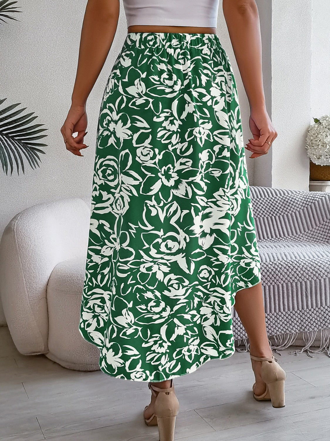 Dark green floral print midi skirt with an asymmetric hem