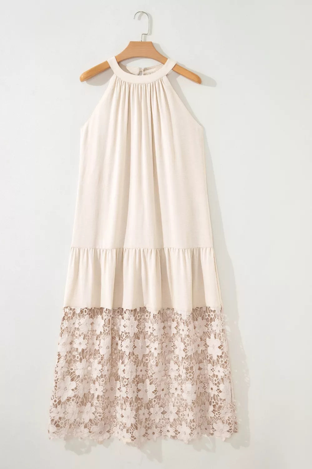 Beige halter maxi dress with tiered skirt and floral lace hem detail