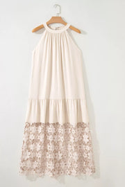 Beige halter maxi dress with tiered skirt and floral lace hem detail