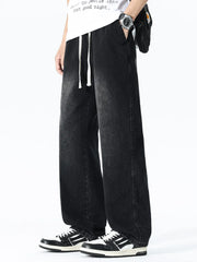 Relaxed wide leg black denim jeans with drawstring waist and pockets.
