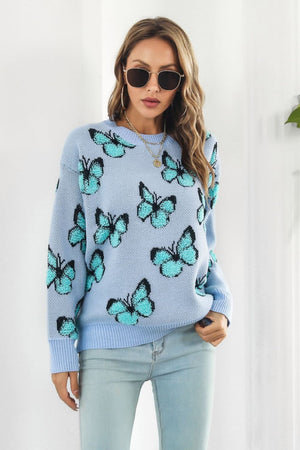 Pastel blue knit crewneck pullover sweater with allover butterfly motif.
