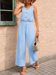 Sky blue wide-leg romper with button detail, drawstring waist, and textured fabric.