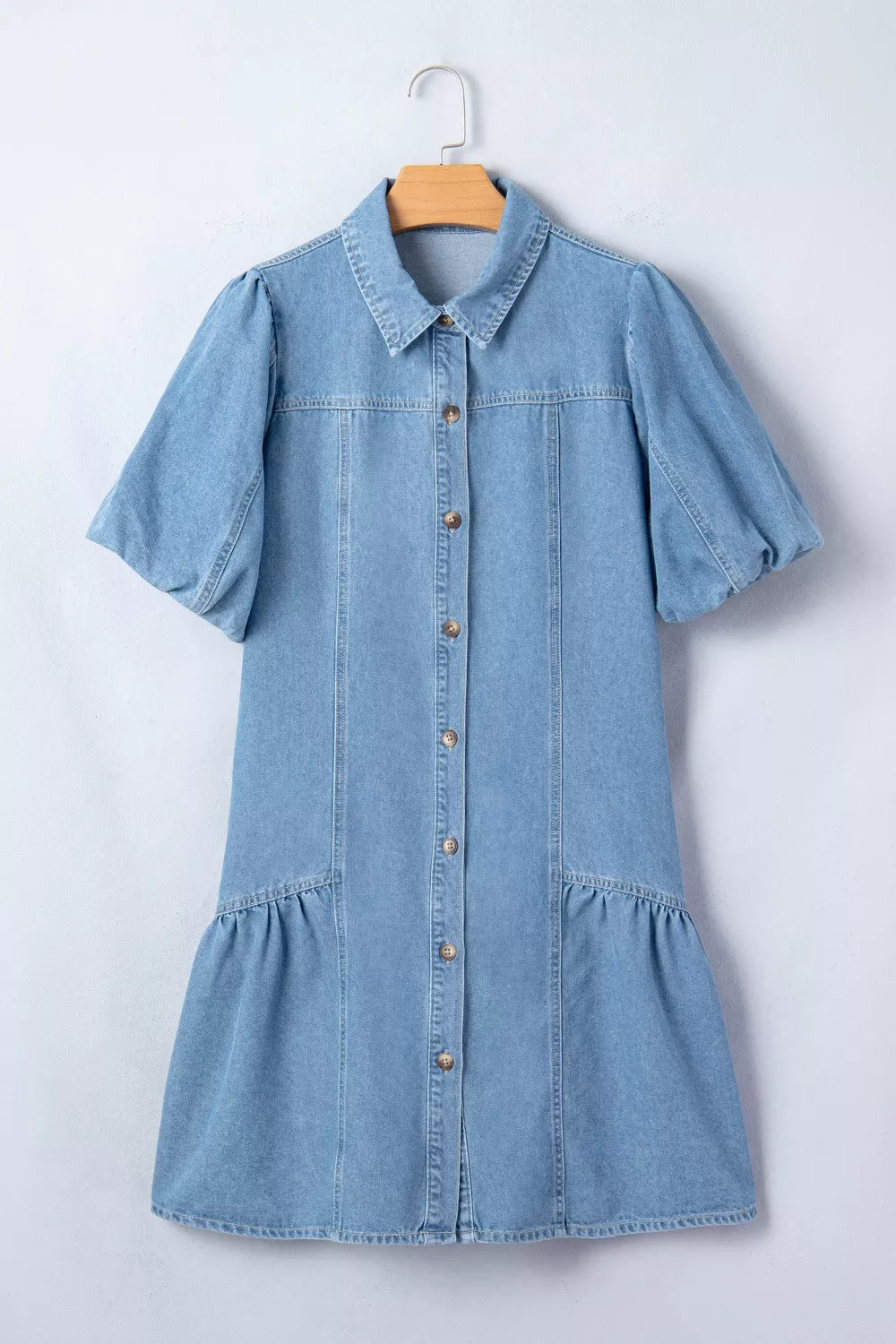 Light blue denim dress with puff sleeves, button front, and ruffled hem.