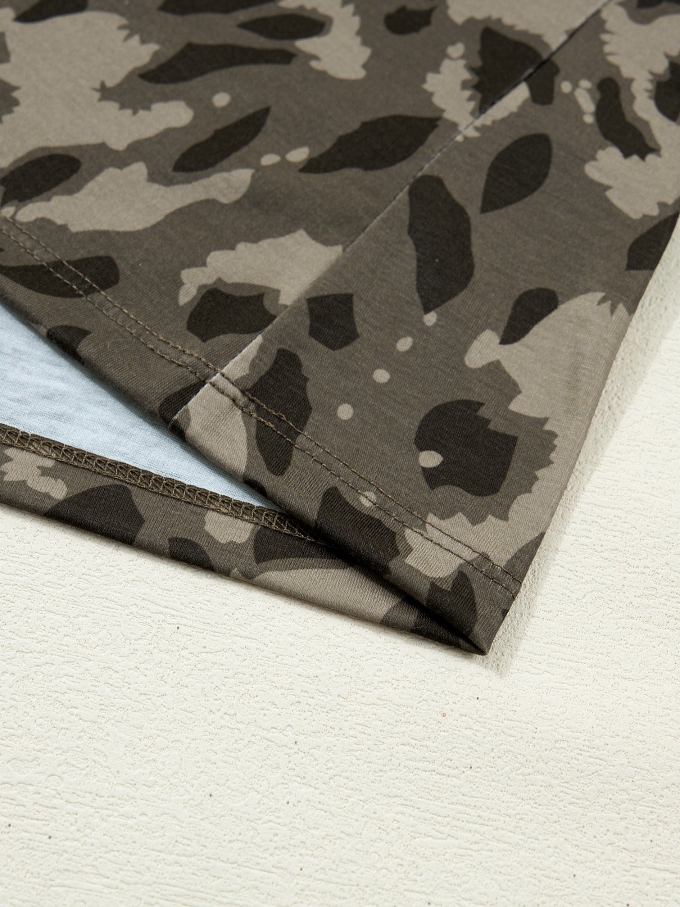 Sleek mock neck slim tee in camouflage print with double-stitched hem detail.