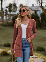 Longline ribbed knit button-down cardigan in rust with pockets and a v-neck.