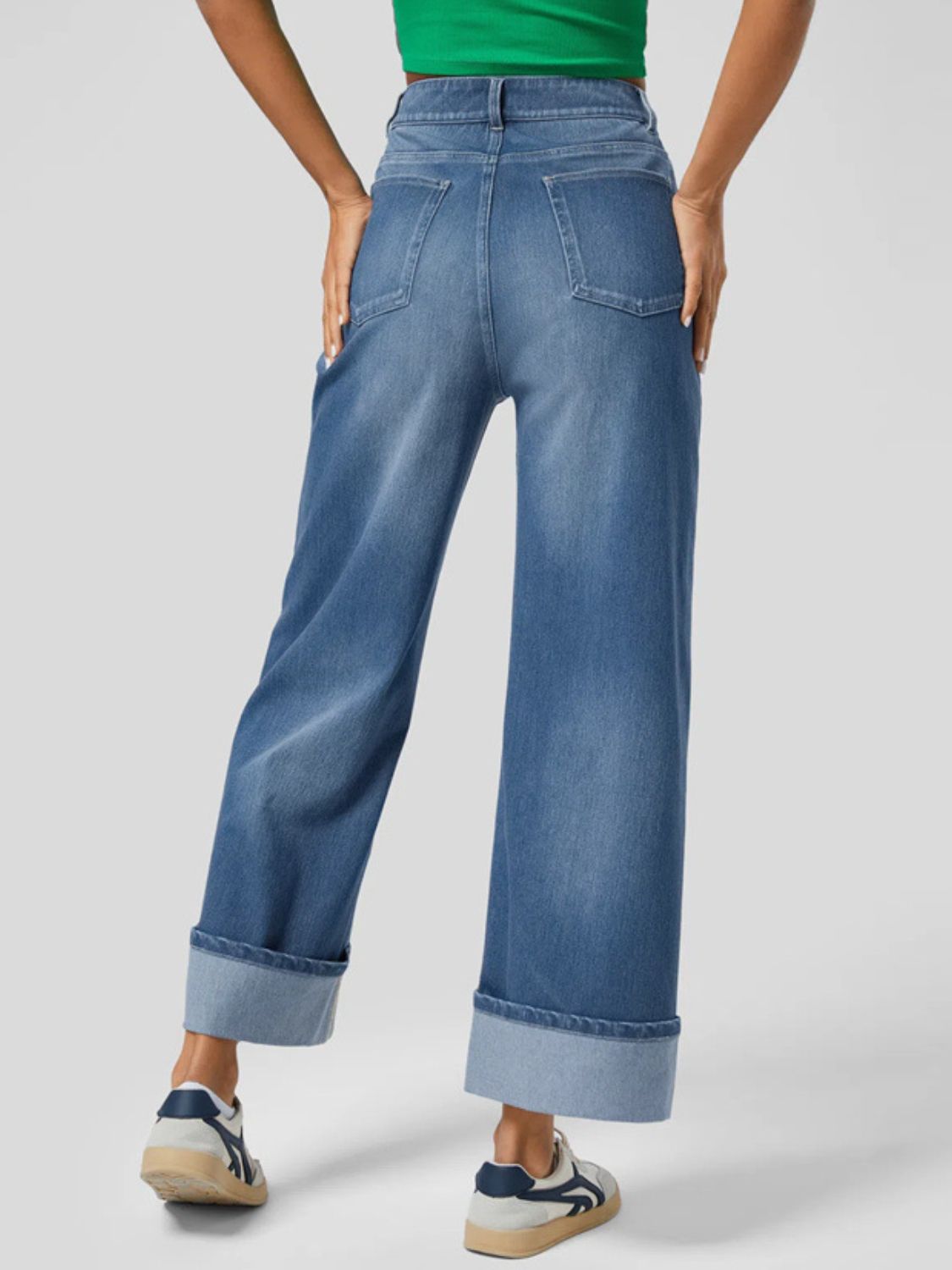 Wide-leg denim jeans in medium wash with a contrast cuff, shown from the back.