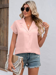 Blush pink textured collared shirt with short sleeves and button front.