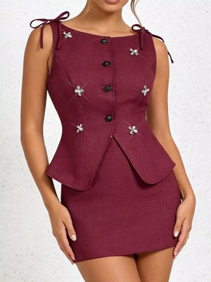 Burgundy tie-shoulder vest with button front and floral appliqués.