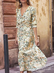 Floral wrap midi dress with ruffled shoulders and a V-neckline.