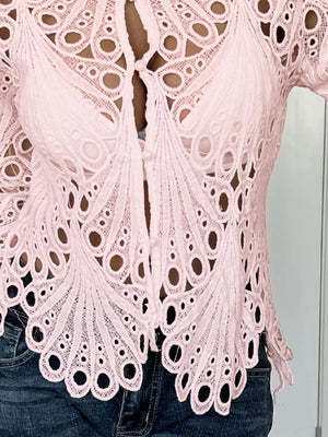 Pink lace button-up blouse with scalloped collar and intricate eyelet pattern.