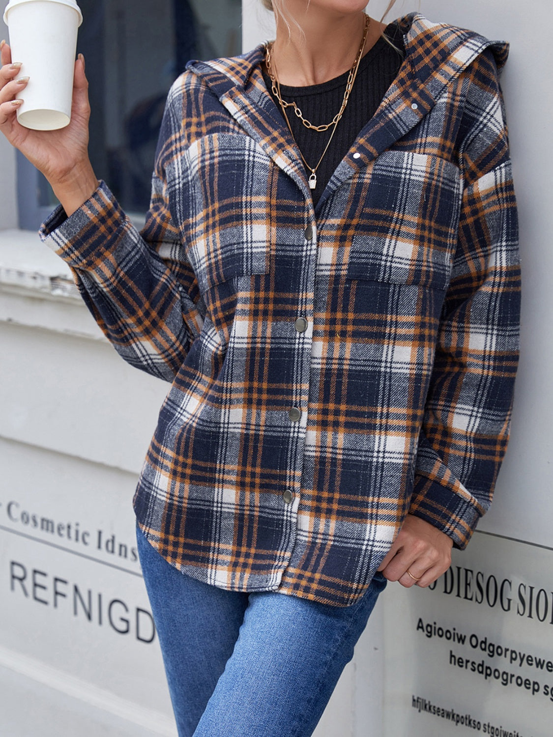 Plaid hooded shacket in navy and brown with button front and relaxed fit.