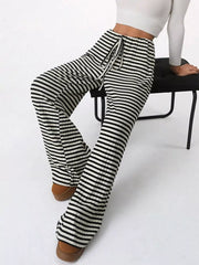 Striped ribbed wide-leg pants with drawstring waist in black and white.