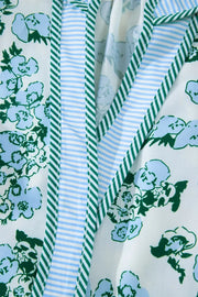 Floral print polyester blouse with ruffled trim and striped details