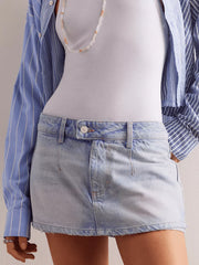Light blue denim mini skort with button closure and frayed hem.