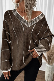 Coffee brown knit oversized v-neck sweater with white stripe details and waffle texture.