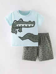 Light blue cotton toddler tee with crocodile graphic and grey shorts with arc pattern.