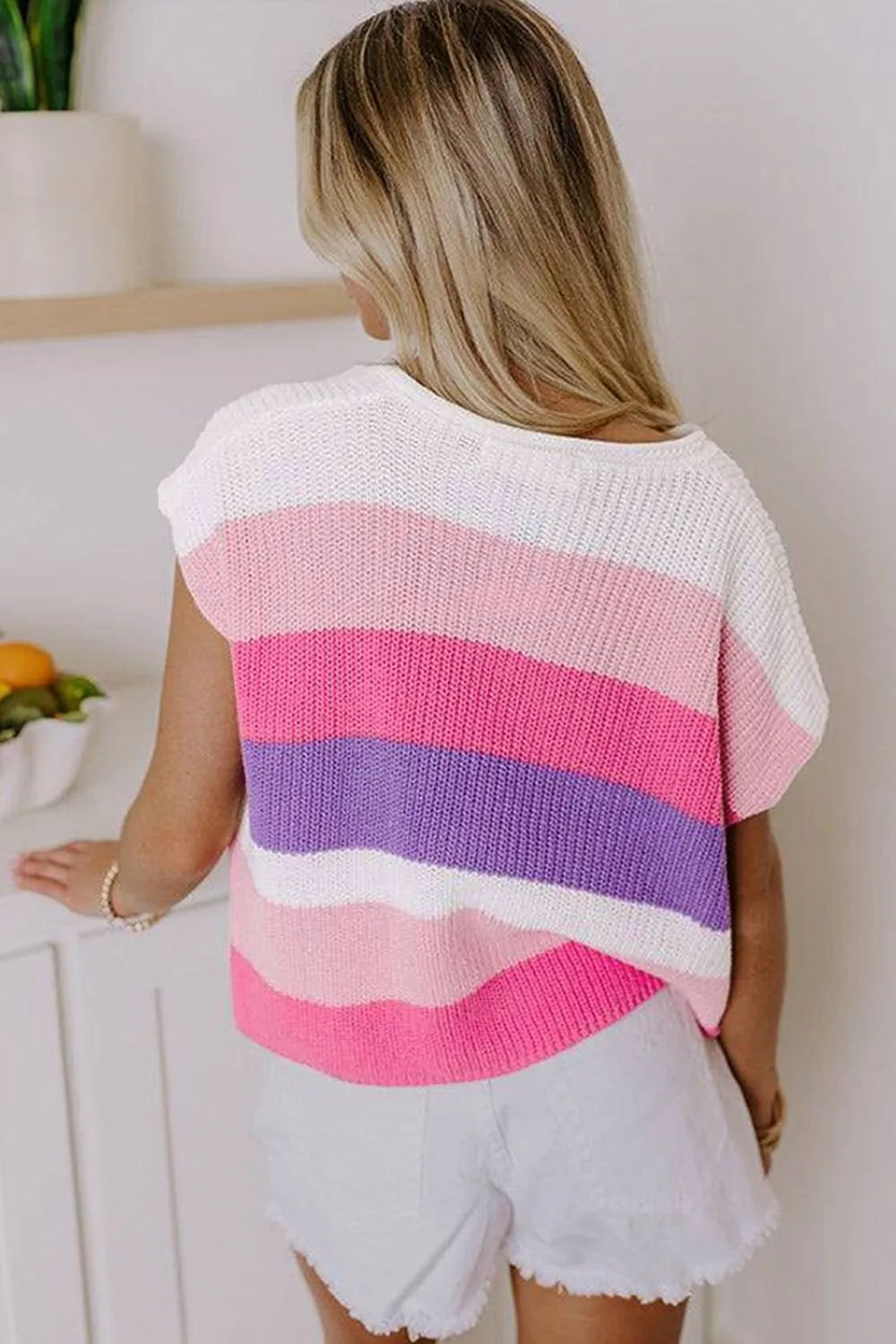 Colorblock knit polo top with short sleeves in pink, purple, and white stripes.
