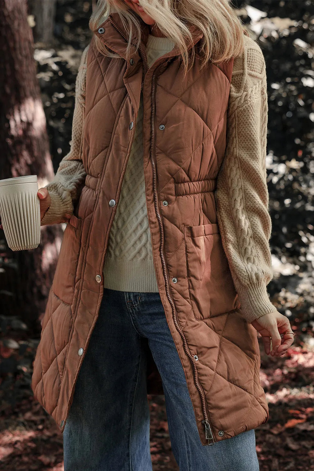 Brown diamond quilted longline vest with cinched waist detail and snap front.